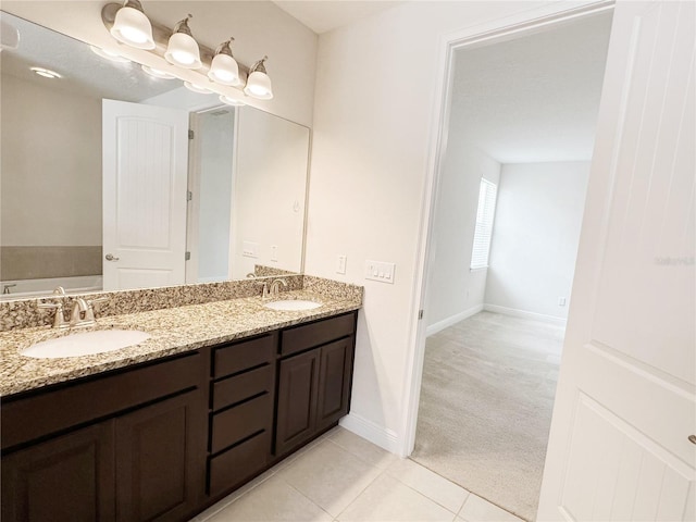 full bathroom with tile patterned flooring, double vanity, a bath, and a sink