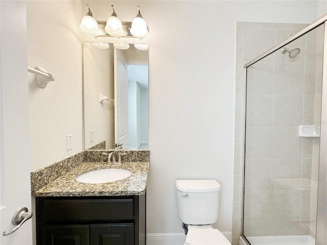 bathroom featuring vanity, toilet, and tiled shower