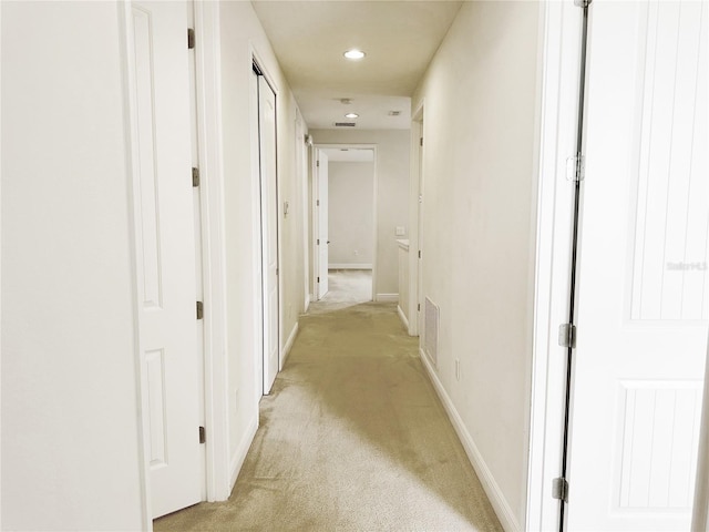 hall featuring recessed lighting, visible vents, baseboards, and light carpet