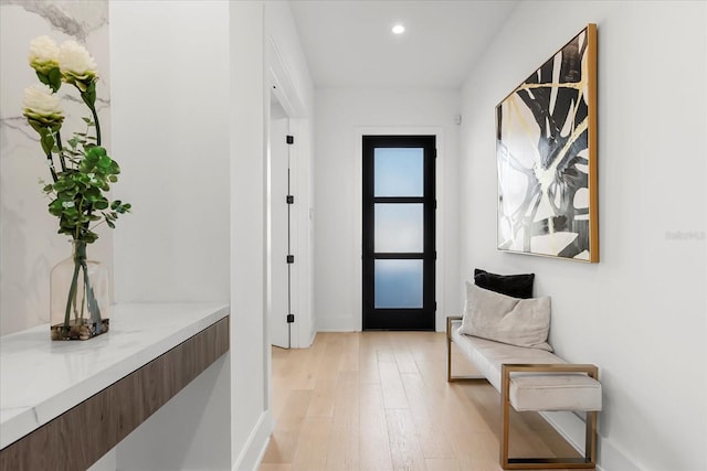 hallway with recessed lighting, baseboards, and light wood-style floors