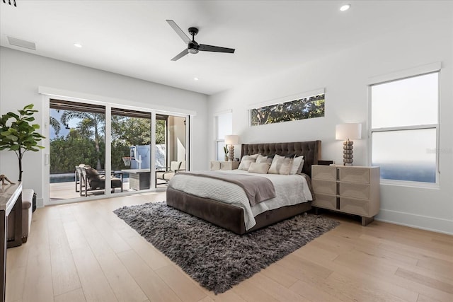 bedroom with recessed lighting, light wood-type flooring, and access to outside