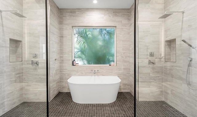 bathroom featuring a soaking tub and a stall shower