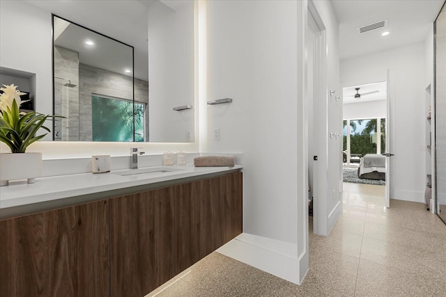 ensuite bathroom with visible vents, ensuite bathroom, a shower with door, baseboards, and vanity