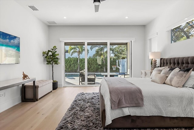 bedroom featuring access to exterior, visible vents, multiple windows, and light wood-type flooring