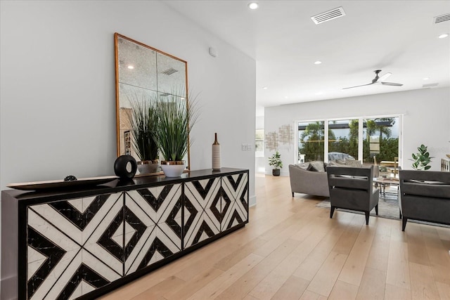 hall featuring visible vents, recessed lighting, and light wood-type flooring