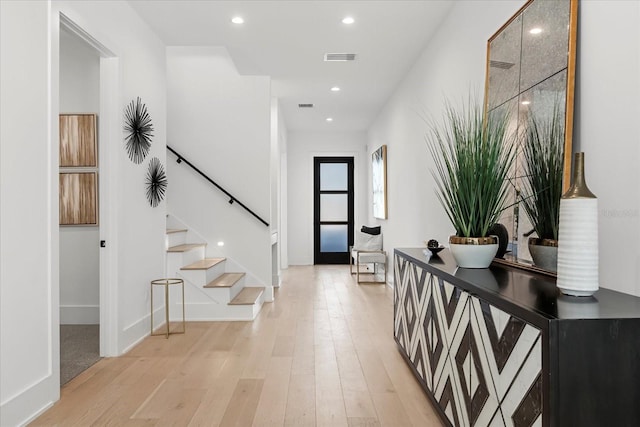 foyer entrance with stairway, recessed lighting, visible vents, and light wood-type flooring