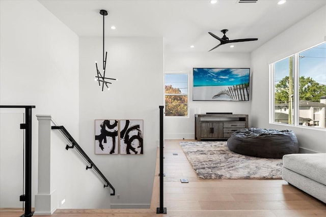 living area featuring a ceiling fan, recessed lighting, and wood finished floors