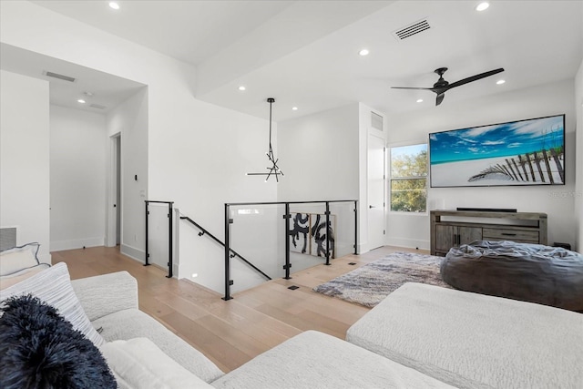 living room featuring recessed lighting, wood finished floors, and visible vents