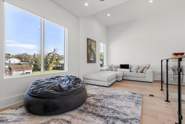 living area with recessed lighting, baseboards, and light wood finished floors