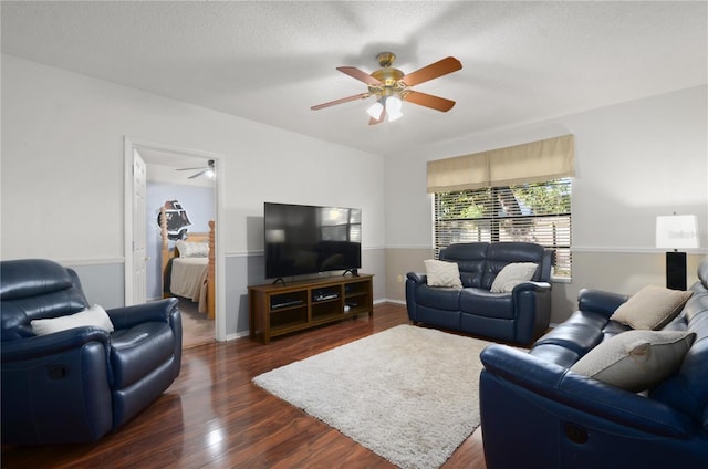 living room with dark wood-style floors, baseboards, a textured ceiling, and ceiling fan