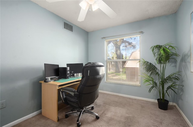 office area with visible vents, baseboards, ceiling fan, and carpet flooring