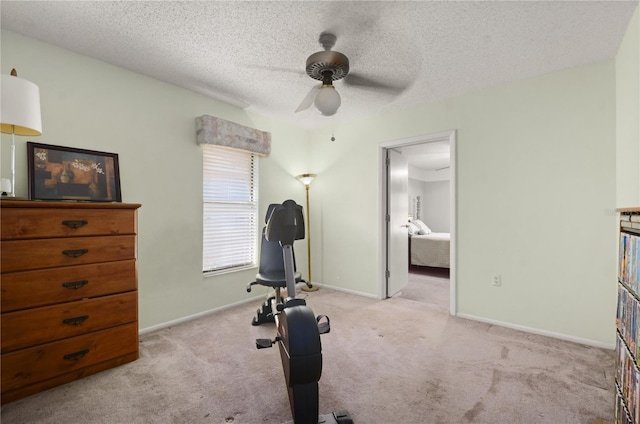 workout area with baseboards, carpet, a ceiling fan, and a textured ceiling