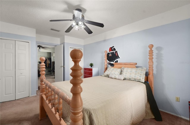 bedroom featuring visible vents, baseboards, ceiling fan, carpet, and a textured ceiling