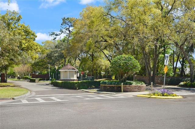 view of road featuring traffic signs and curbs