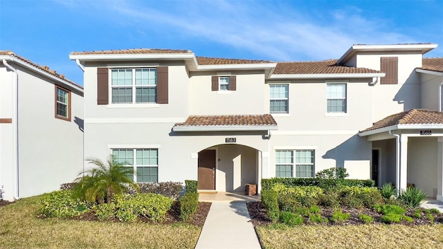 mediterranean / spanish home with stucco siding and a tile roof