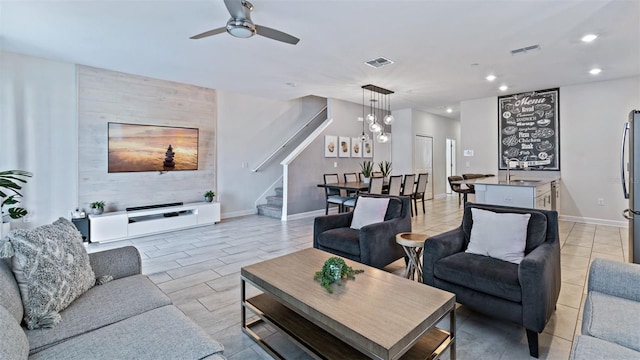 living area featuring stairs, recessed lighting, visible vents, and baseboards