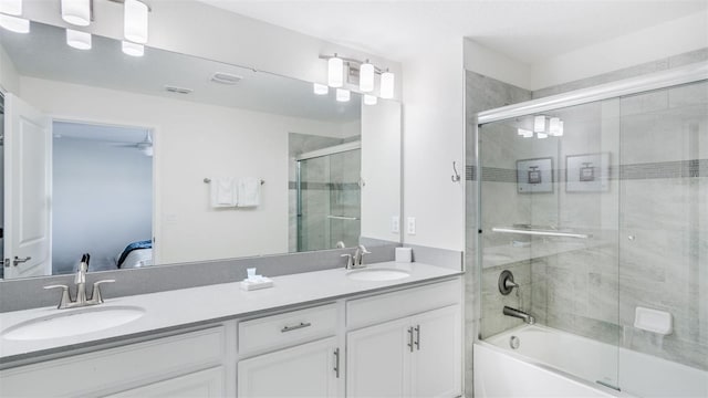 ensuite bathroom featuring double vanity, combined bath / shower with glass door, ensuite bathroom, and a sink