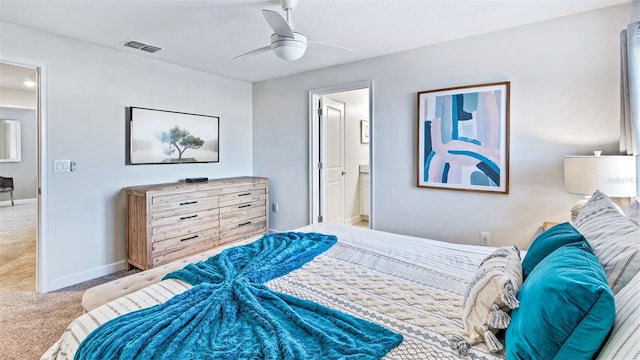 bedroom with a ceiling fan, baseboards, visible vents, ensuite bathroom, and carpet flooring