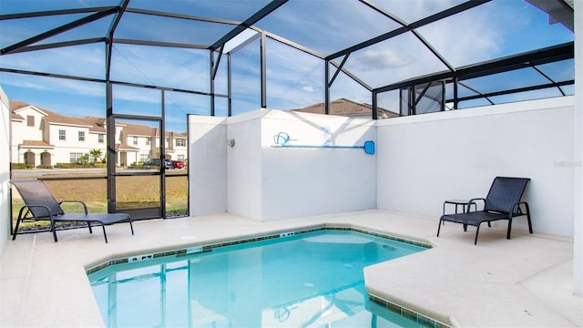 outdoor pool with a lanai, a residential view, and a patio