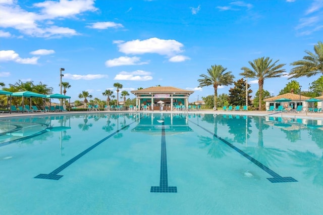 community pool featuring a gazebo and a patio area