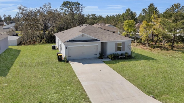 ranch-style home with central air condition unit, an attached garage, concrete driveway, and a front yard