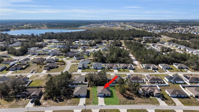 birds eye view of property with a water view and a residential view