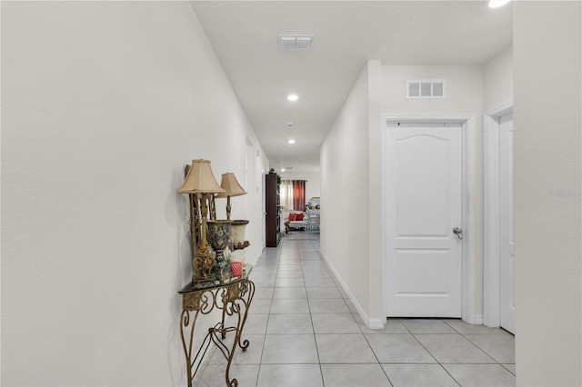 hallway with recessed lighting, light tile patterned flooring, baseboards, and visible vents