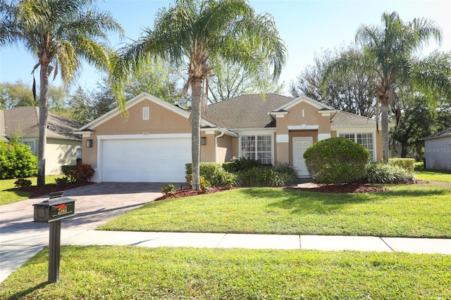 ranch-style house featuring a front yard, decorative driveway, a garage, and stucco siding