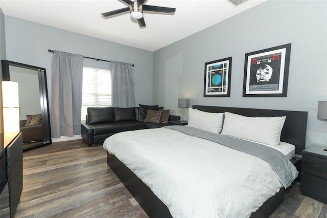 bedroom featuring visible vents, dark wood-type flooring, and ceiling fan