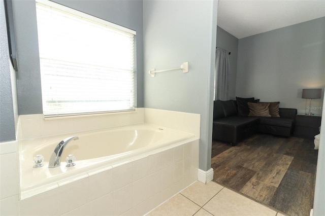 bathroom featuring tile patterned flooring and a bath