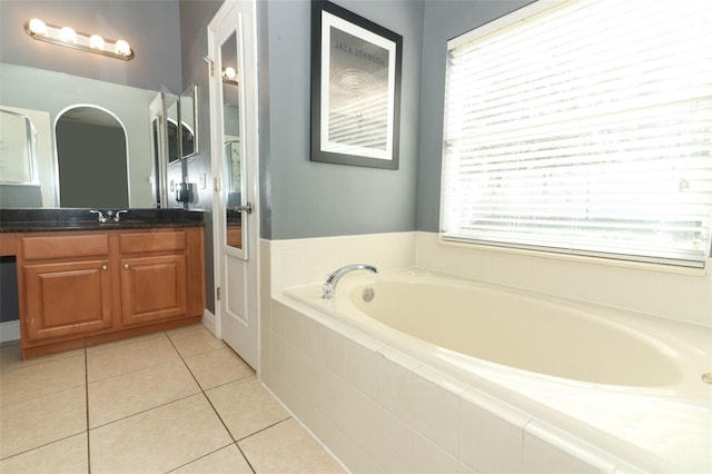 full bathroom with tile patterned floors, plenty of natural light, vanity, and a garden tub