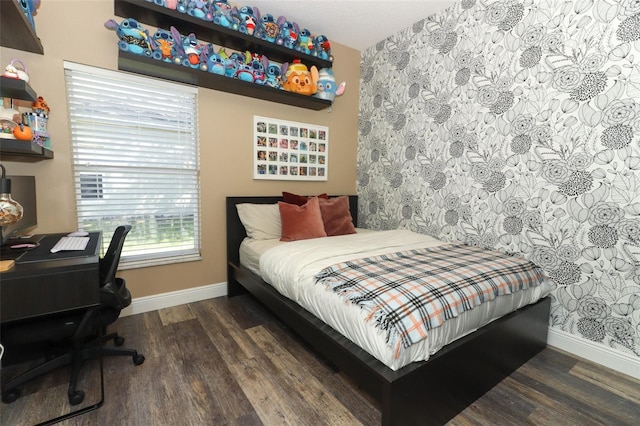 bedroom featuring wood finished floors and baseboards