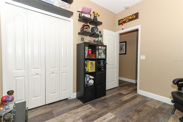 interior space with baseboards and dark wood finished floors