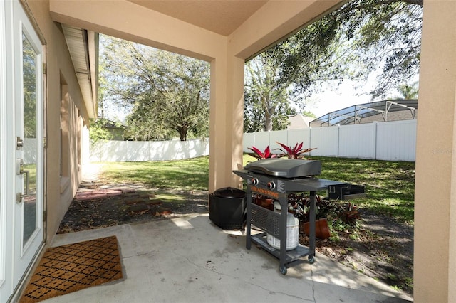 view of patio with a grill and a fenced backyard