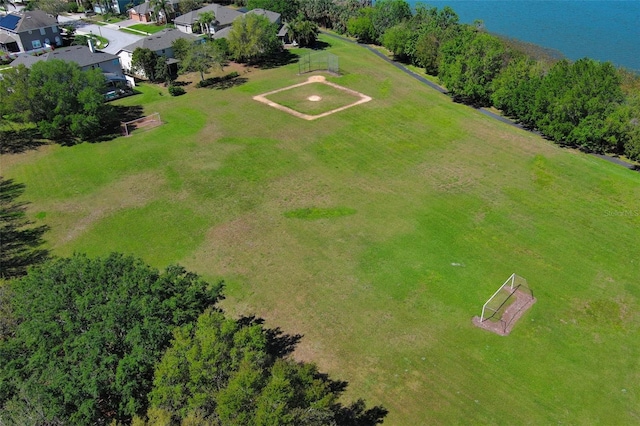 drone / aerial view featuring a residential view and a water view