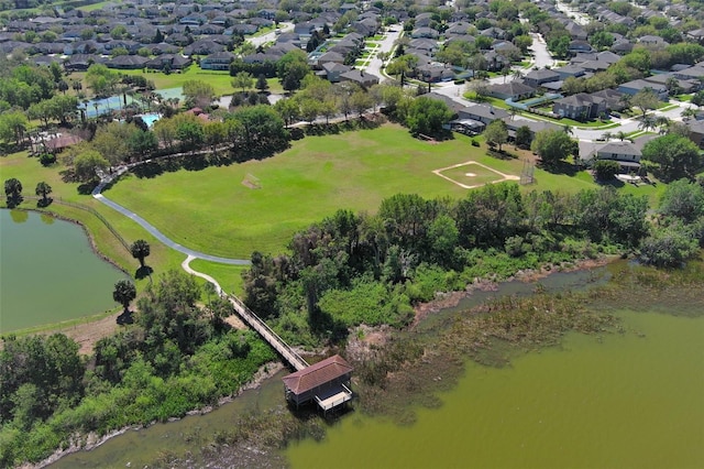 birds eye view of property with a water view and a residential view