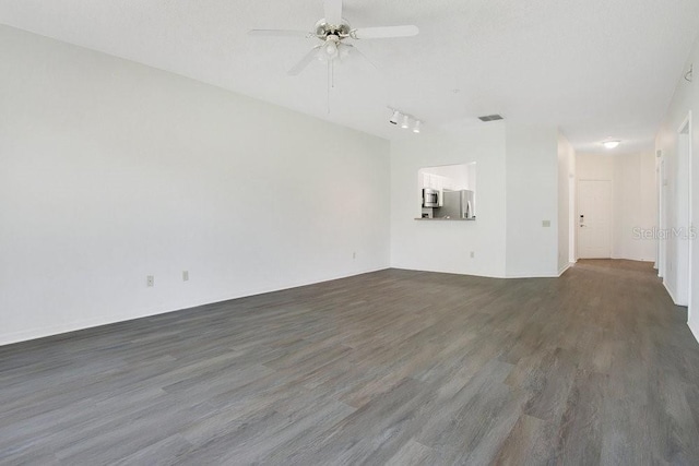 unfurnished living room with visible vents, wood finished floors, and a ceiling fan