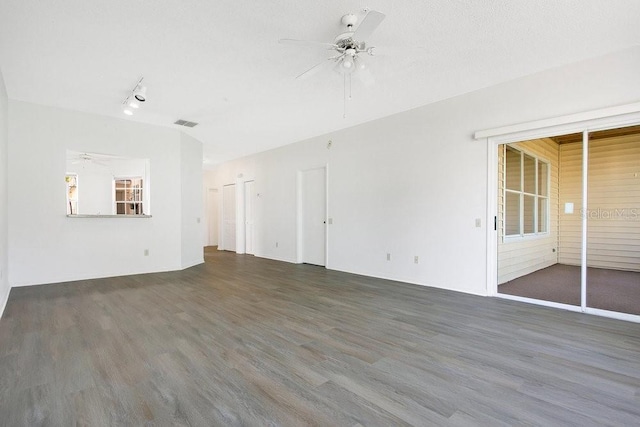 unfurnished living room with a textured ceiling, wood finished floors, visible vents, and ceiling fan