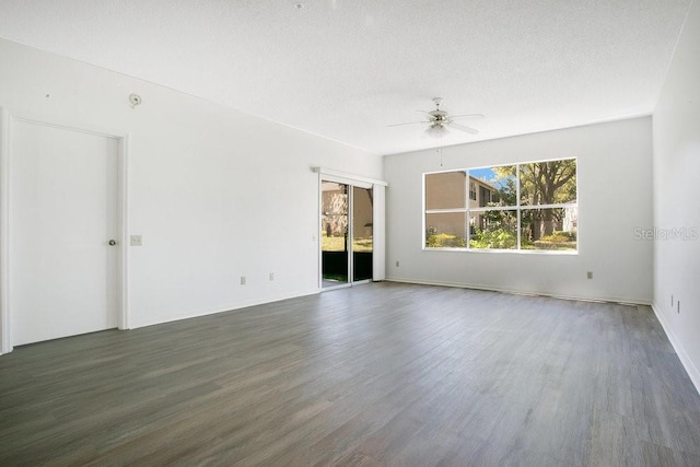 spare room featuring a textured ceiling, wood finished floors, and ceiling fan