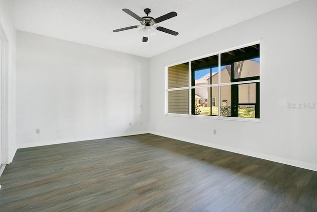 unfurnished room featuring baseboards, a ceiling fan, and wood finished floors