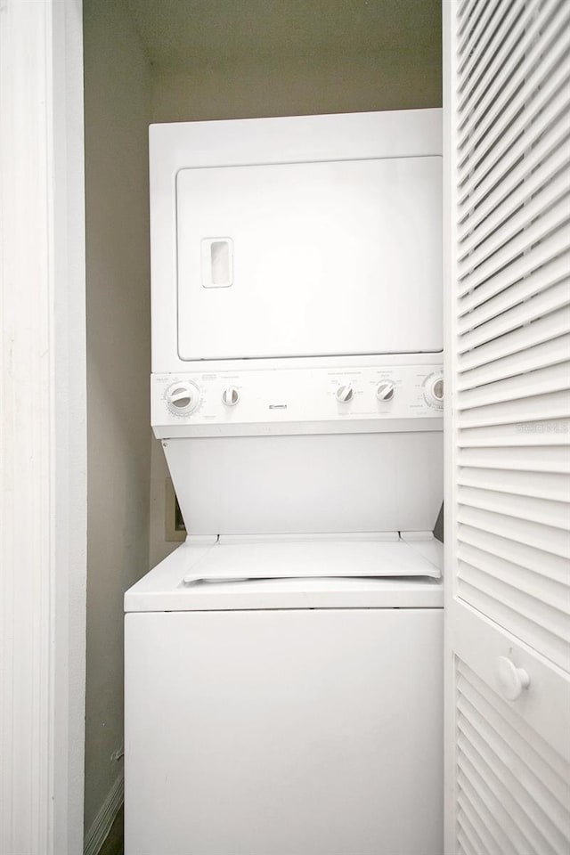 laundry area with laundry area and stacked washer / dryer