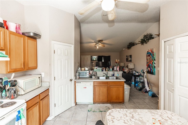 kitchen featuring a ceiling fan, white appliances, a peninsula, light tile patterned flooring, and light countertops