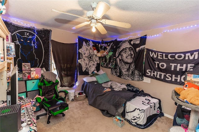 carpeted bedroom with a textured ceiling and a ceiling fan