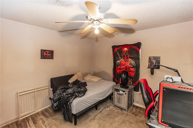 carpeted bedroom with a textured ceiling and ceiling fan