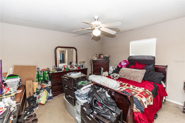 bedroom featuring baseboards, carpet flooring, a textured ceiling, and a ceiling fan