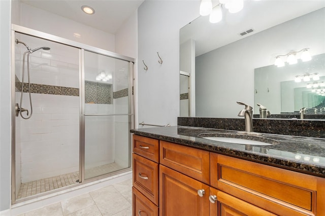 full bathroom featuring vanity, tile patterned floors, visible vents, and a stall shower