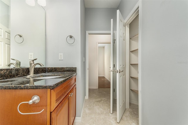 bathroom with vanity and baseboards