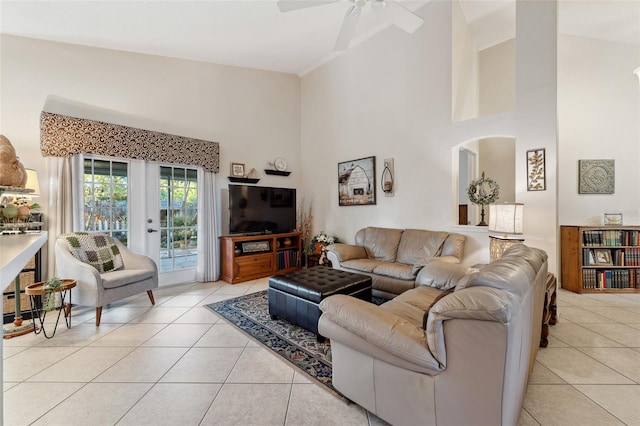 living room featuring french doors, a high ceiling, light tile patterned flooring, and a ceiling fan