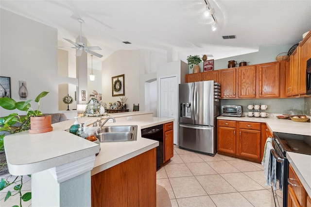 kitchen featuring black appliances, light countertops, and a kitchen island with sink