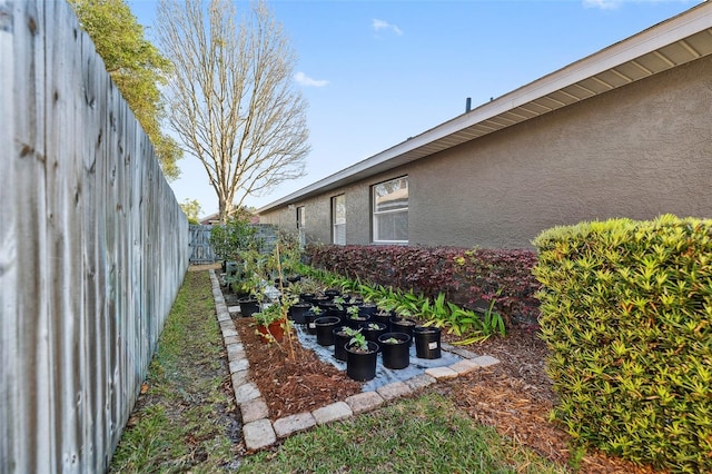 view of yard with a vegetable garden and fence